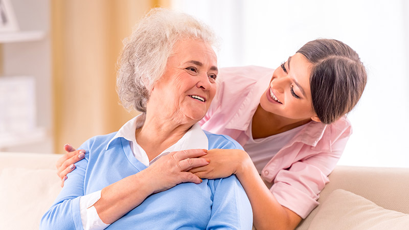 Care-of-senior-woman-at-home-sitting-on-the-couch